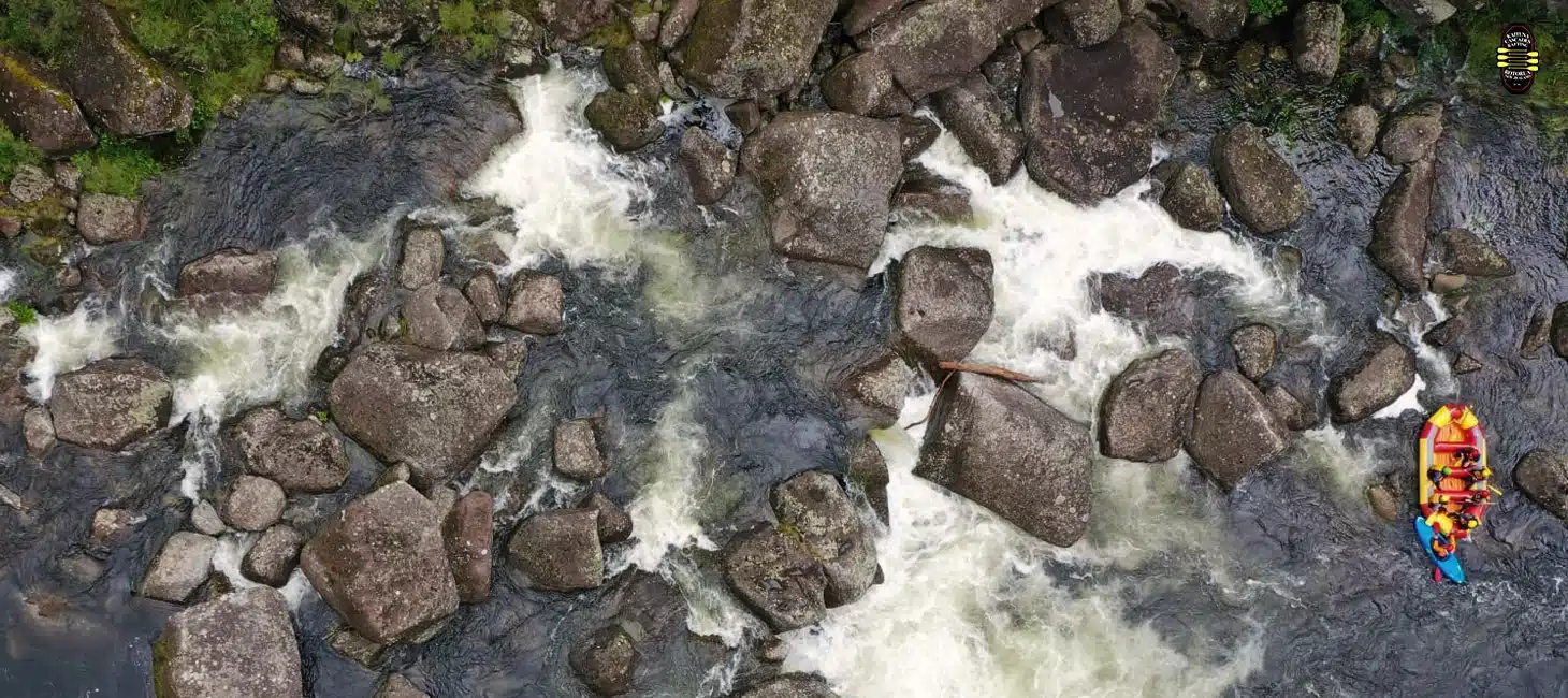 Aerial view of rafters navigating rocky whitewater rapids on the Wairoa River
