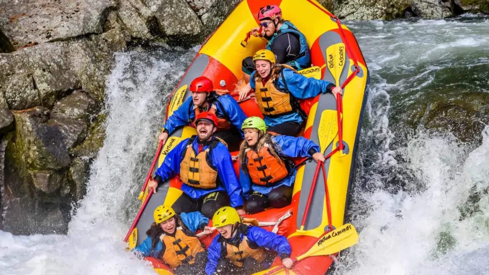 A group of people having fun white water rafting in Wairoa
